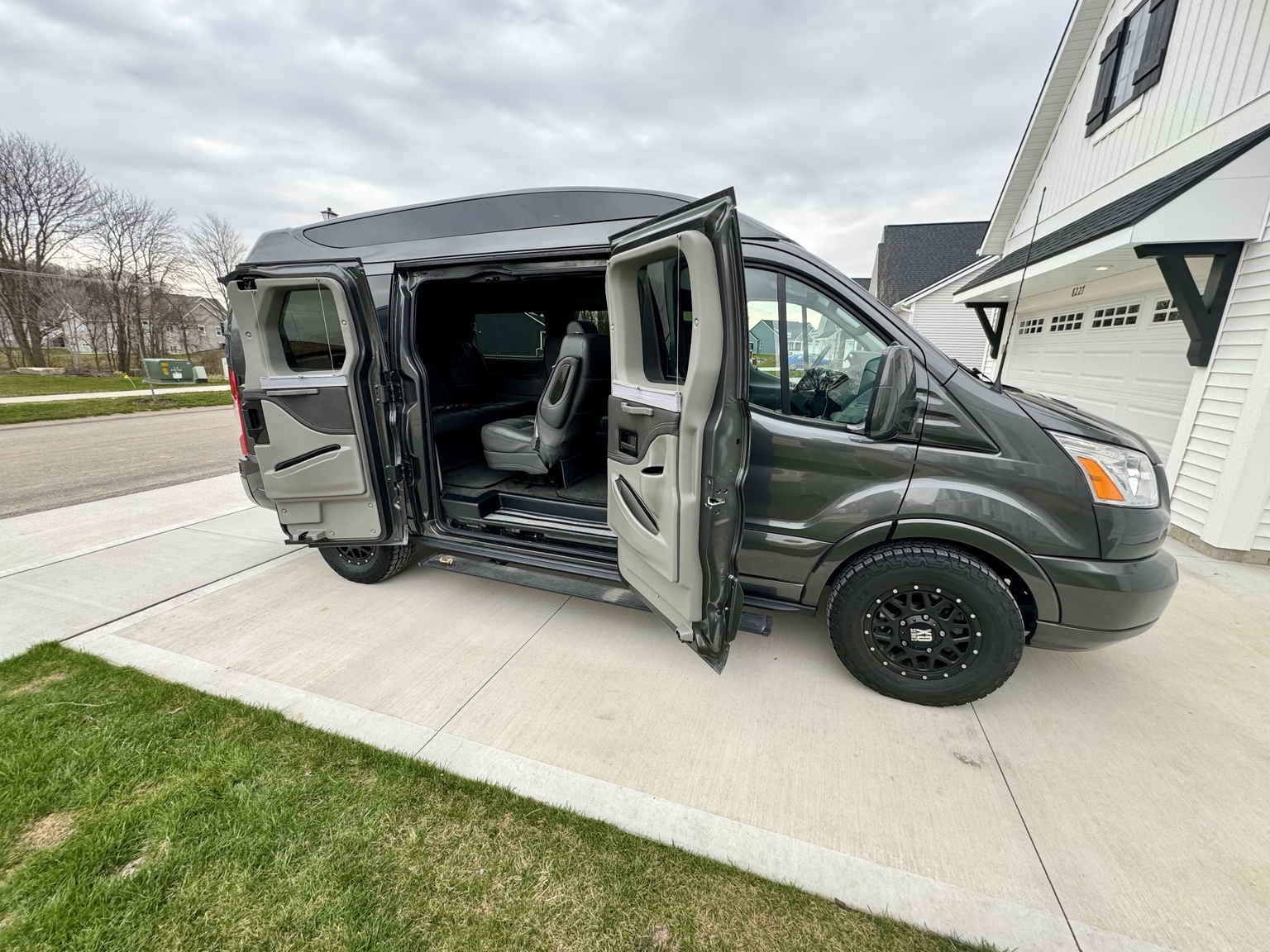 Passenger doors open on both sides of the Gig-Van